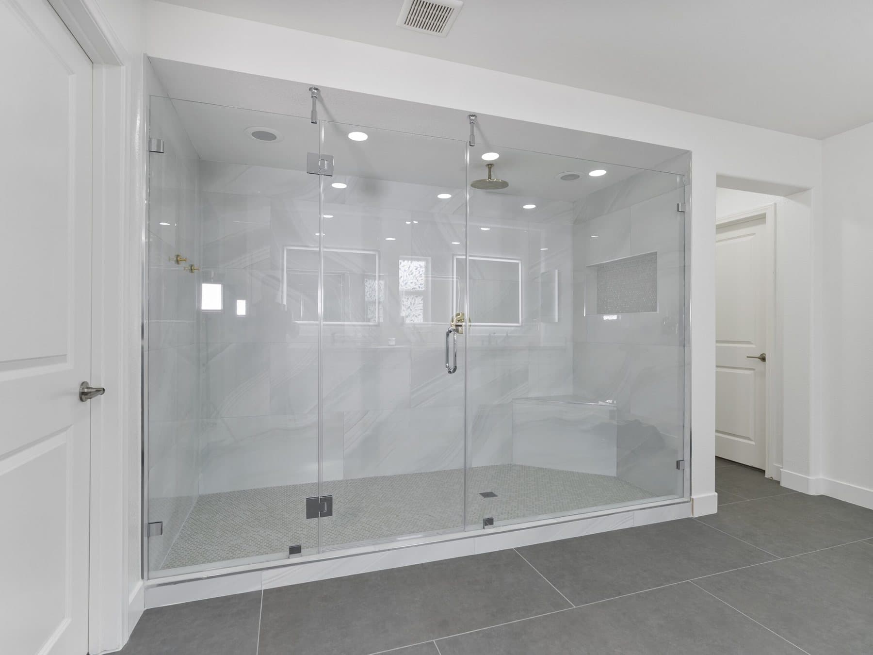 Lone Mountain bathroom remodel: frameless glass shower enclosure from the doorway
