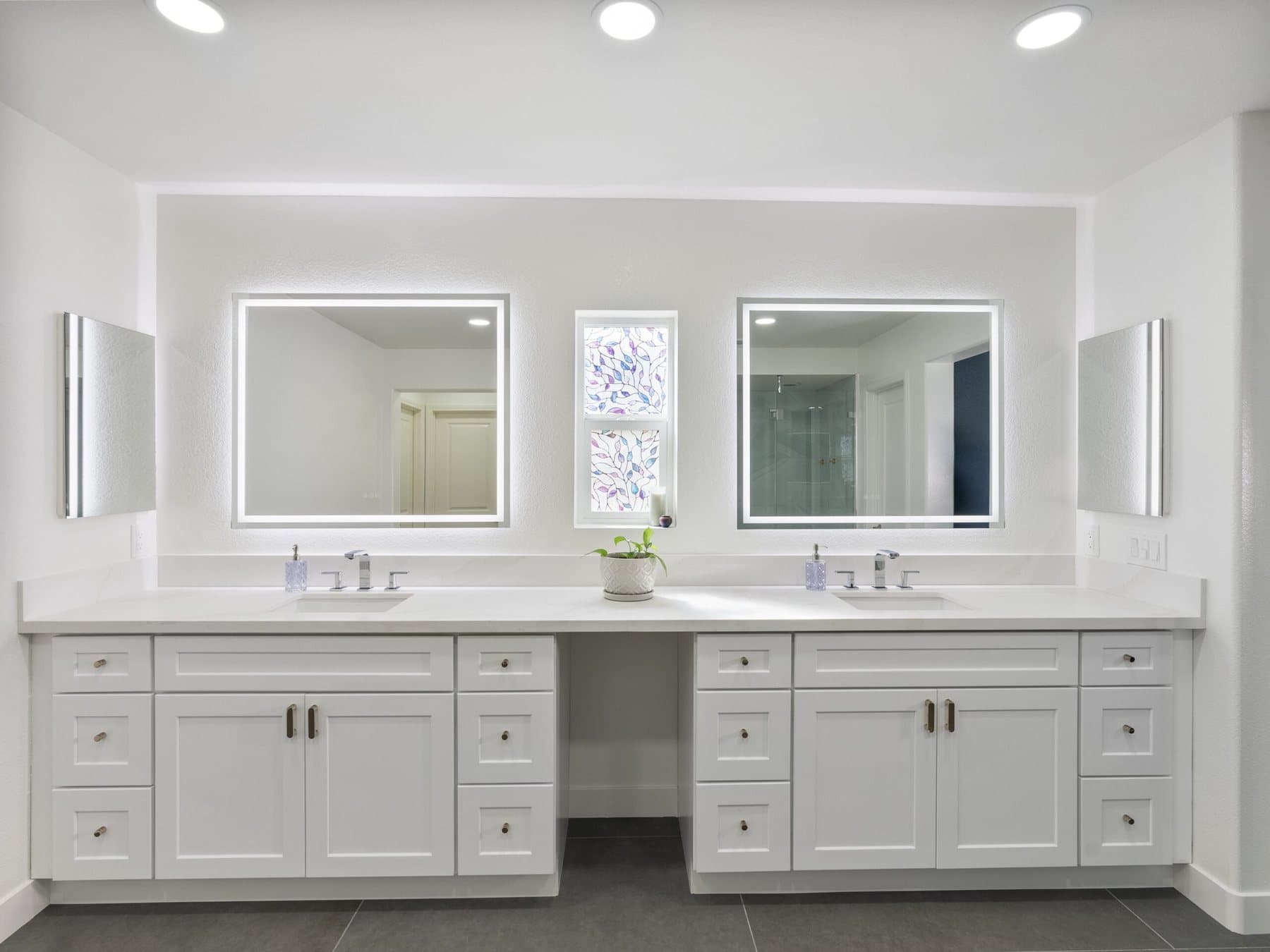 Lone Mountain bathroom remodel: double vanity with LED-lit mirrors and makeup counter