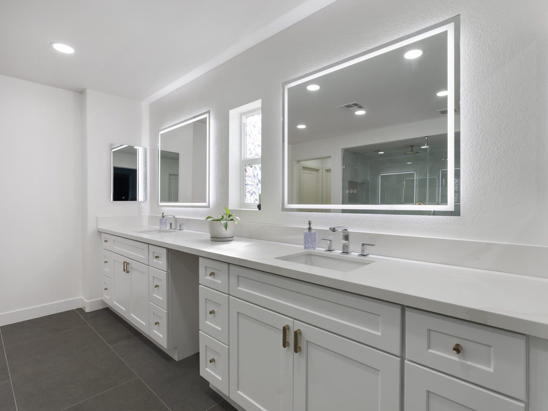 Lone Mountain bathroom remodel: vanity wall with LED-lit mirrors