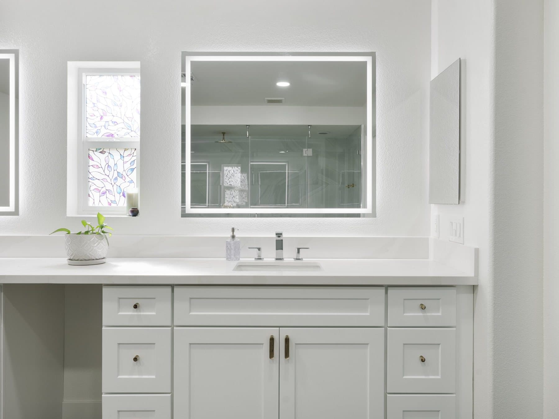Lone Mountain bathroom remodel: vanity with LED-lit mirror and white countertop