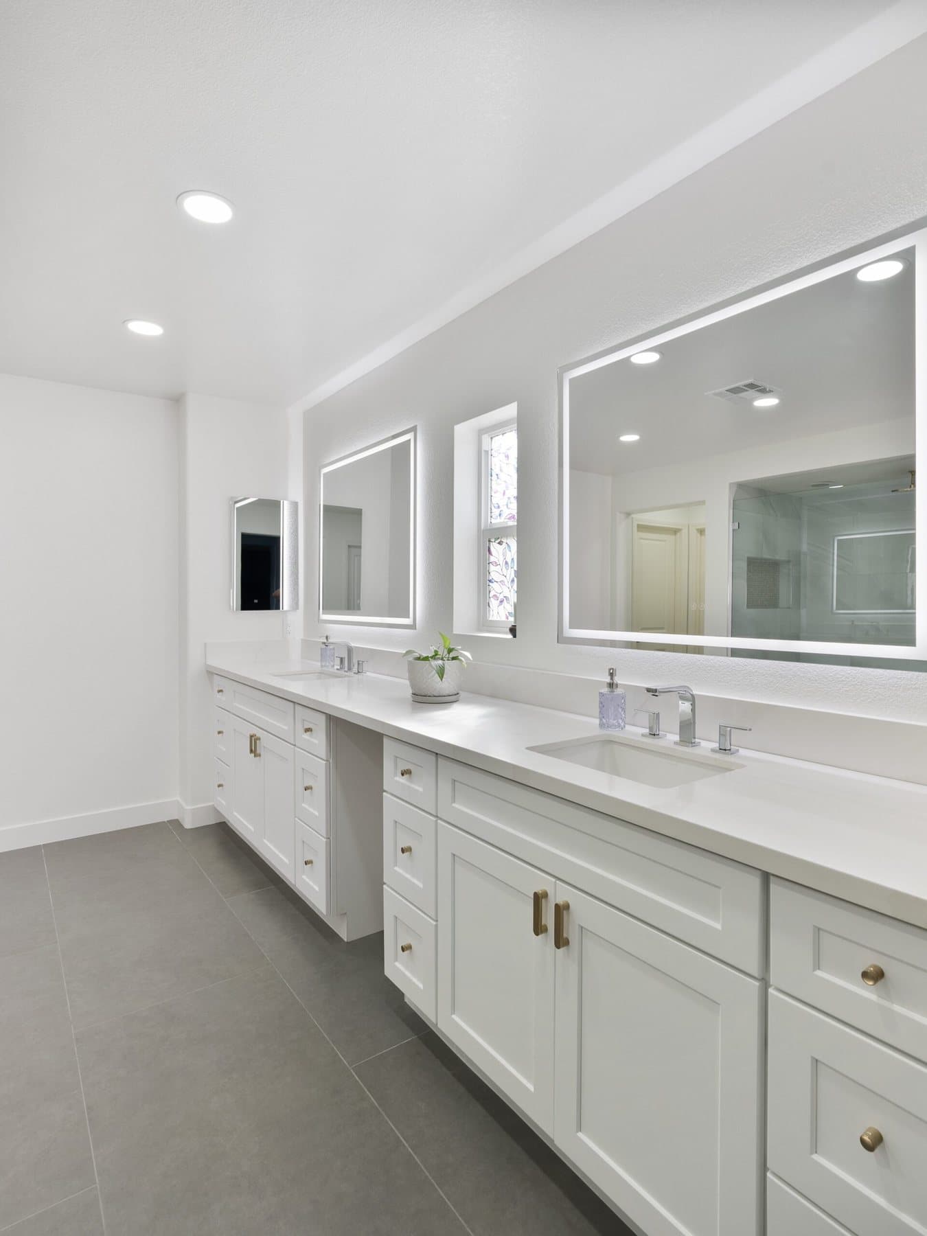 Lone Mountain bathroom remodel: vanity run with LED-lit mirrors