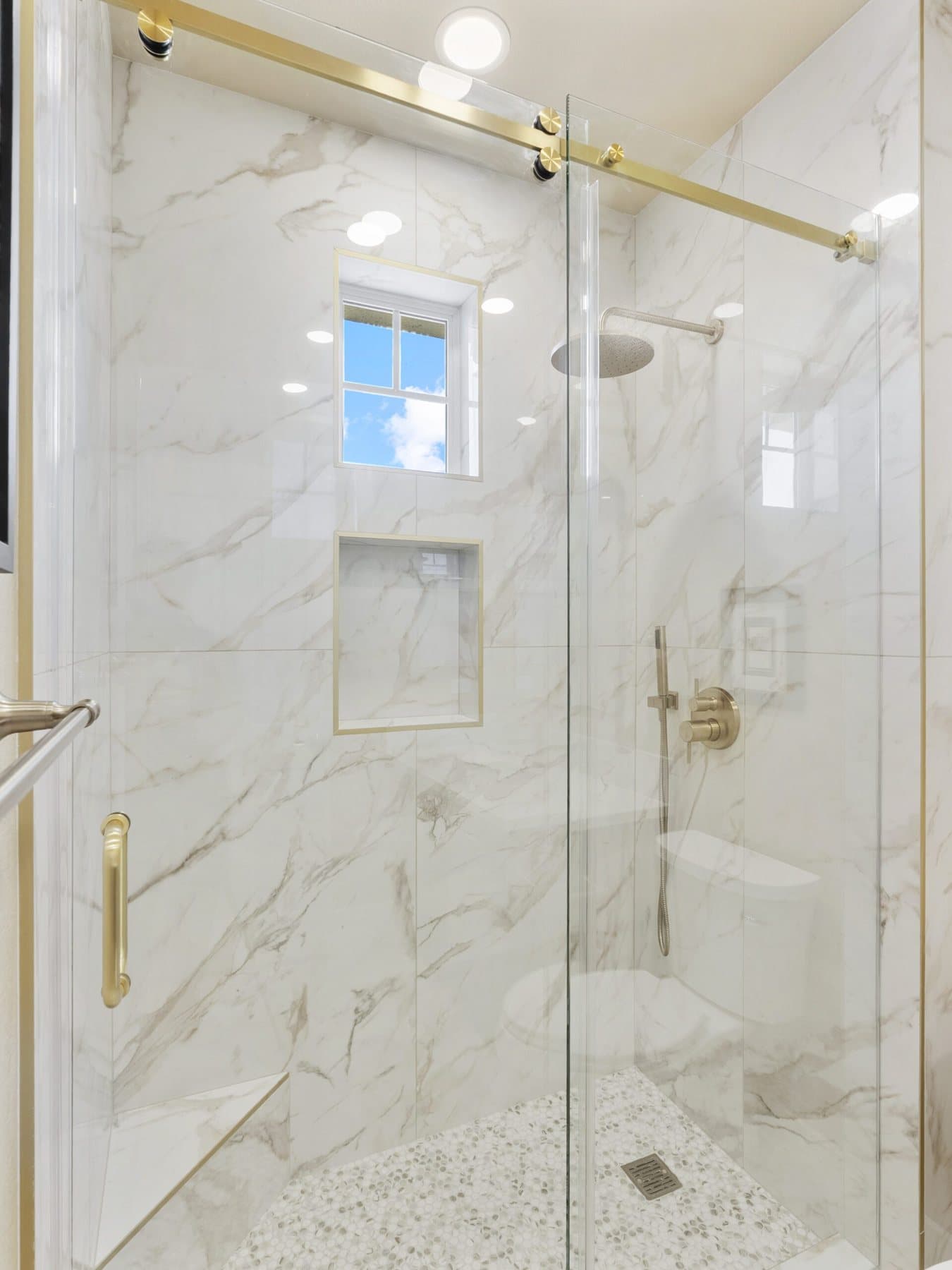 Small bathroom remodel: walk-in shower with sliding glass door and brushed-gold hardware