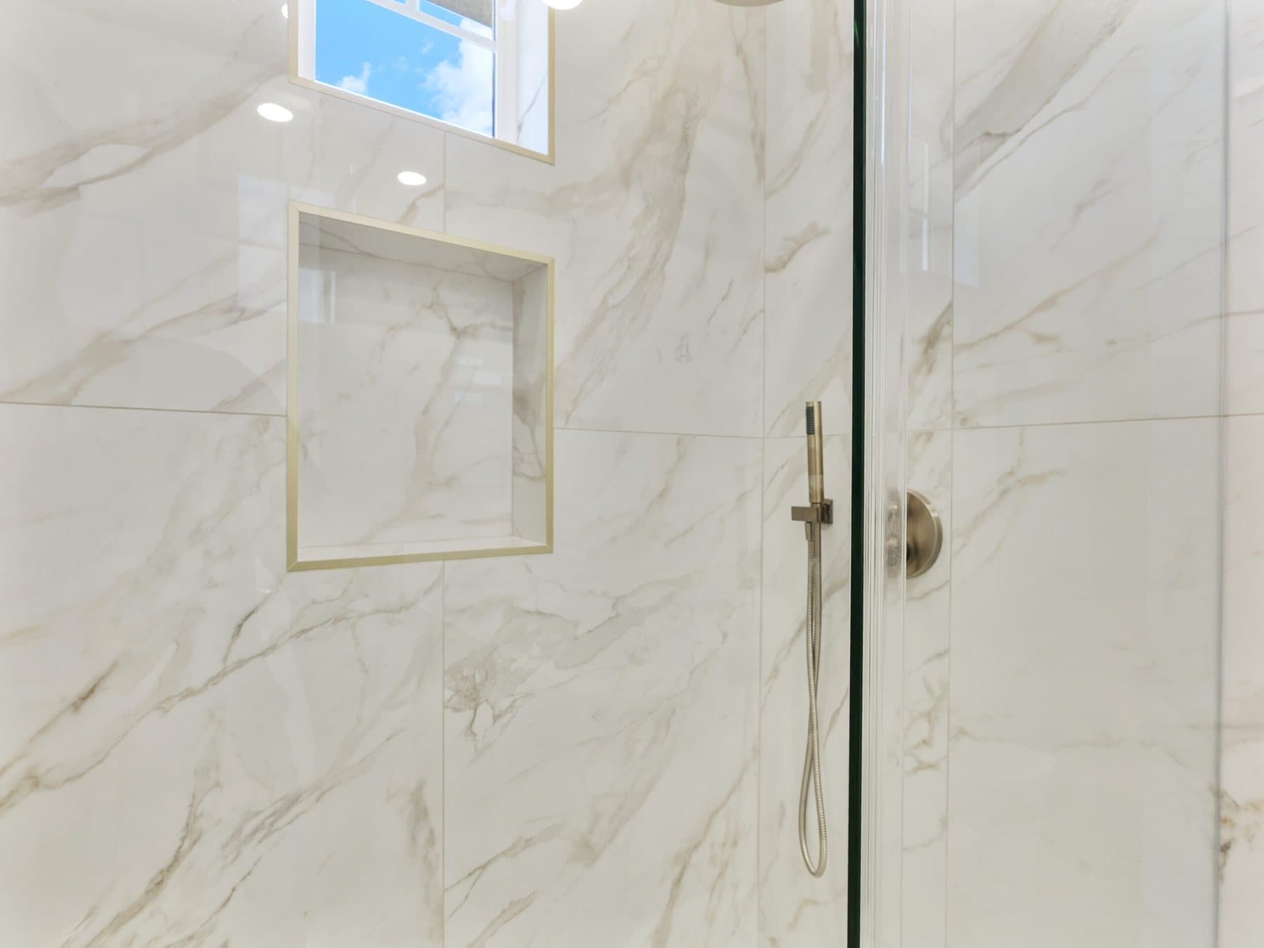 Small bathroom remodel: marble-look shower wall with niche