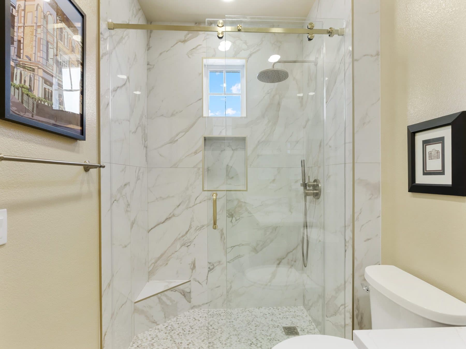 Small bathroom remodel: walk-in shower with frameless glass and window