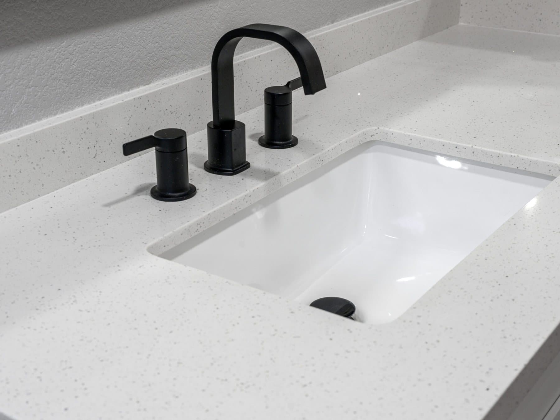 Summerlin bathroom remodel: matte-black widespread faucet on a quartz countertop