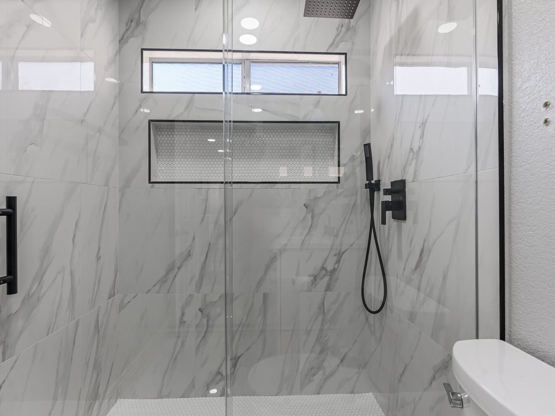 Summerlin bathroom remodel: frameless glass walk-in shower with niche