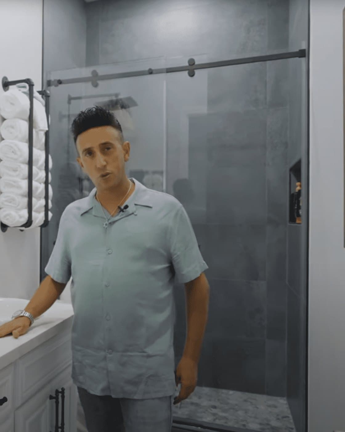 Eran Tsur, owner of Home Design Construction, in a bathroom his team remodeled
